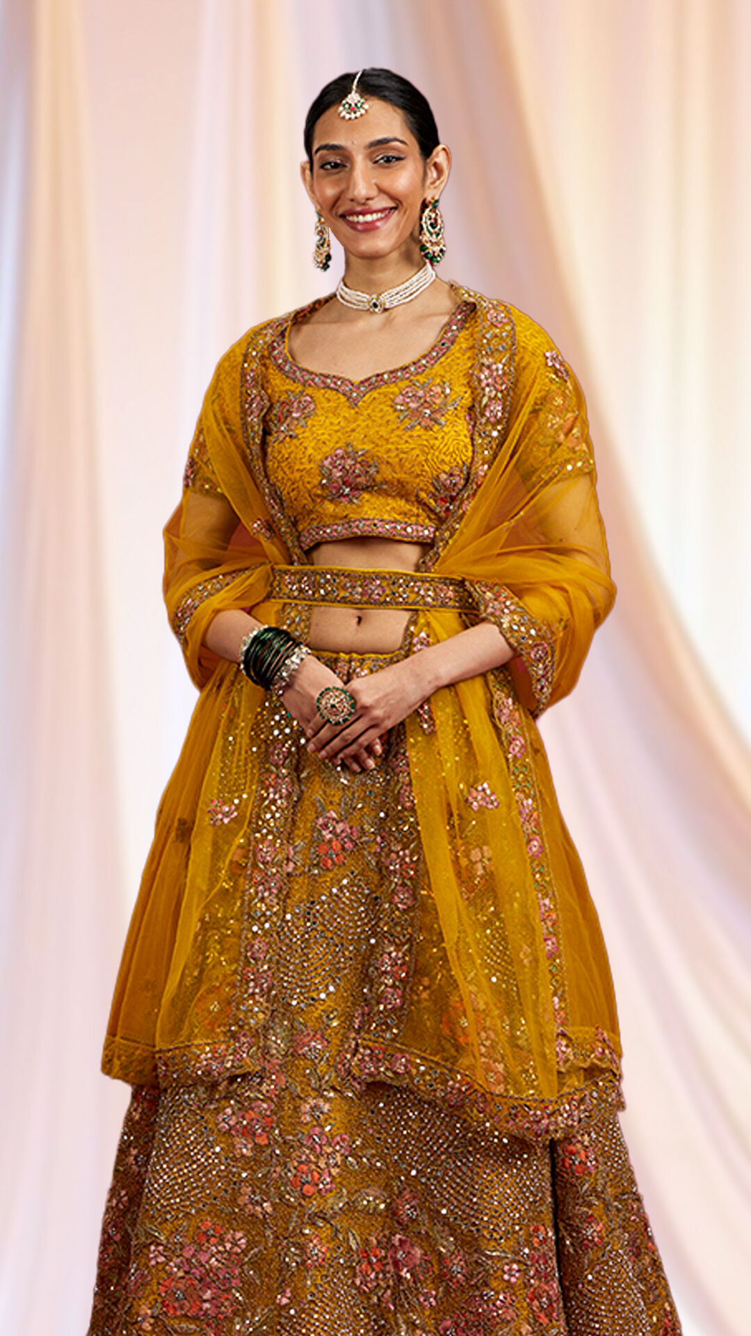 Bride draped in a vibrant yellow dupatta complementing her yellow lehenga.